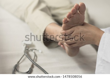 Heel Pain or plantar fasciitis concept. Doctor checking patient foot as suffer from inflammation feet problem of Sever's Disease or calcaneal apophysitis. Royalty-Free Stock Photo #1478508056