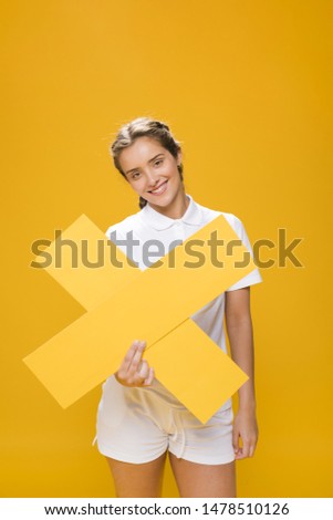 Portrait of a schoolgirl holding a cross