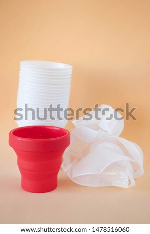 Environmental-friendly collapsible cup or foldable cup made from Silicone on a beige background