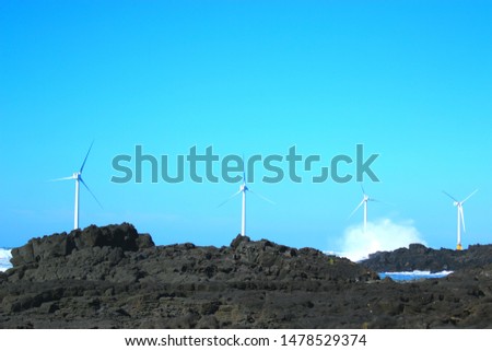 It is the scenery of wind power generator on the coast of Jeju.