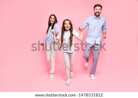 Full size photo of joyful runners moving screaming wearing white t-shirt checkered plaid shirt isolated over pink background