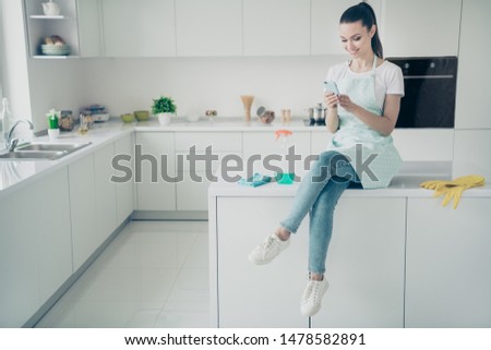 Photo of cheerful nice lady searching for new strategies of rapid cleaning and being about to find something about it