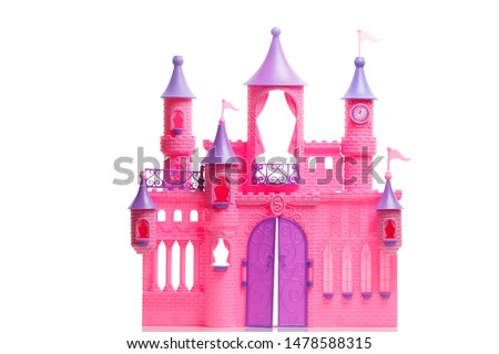 
Children's toy plastic pink сastle for dolls isolated on a white background. For a little girl playing a fairytale princess  of the knights times.