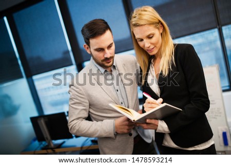 Attractive business couple having discussion in office
