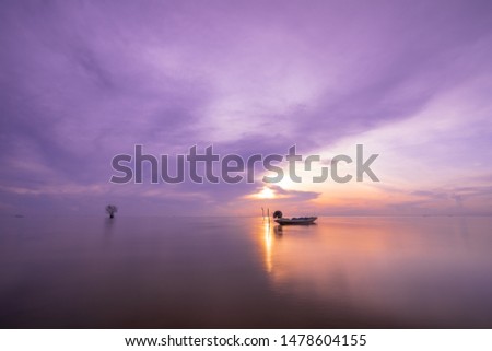 The fishing boat is attached to a small engine parked at Songkhla Lake, Pakpra, Thale Noi Waterfowl Reserve Phatthalung Canal with a beautiful sky background.
