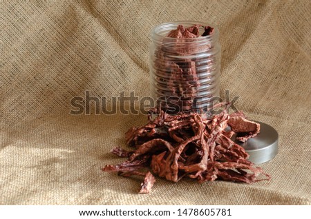 Dried slices for pets. Natural goodies for dogs. Beef lungs on burlap.