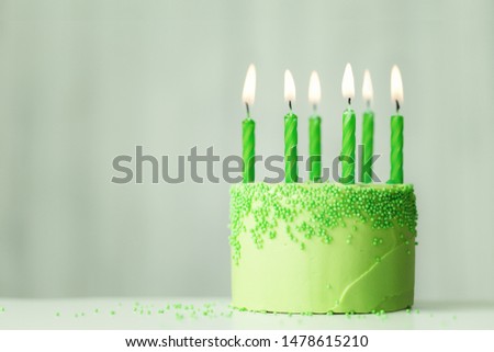 Green birthday cake with green candles