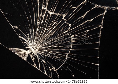 cracks on the broken glass smartphone macro photo