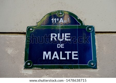 Rue de Malte. White and blue street name plate. Paris, France.