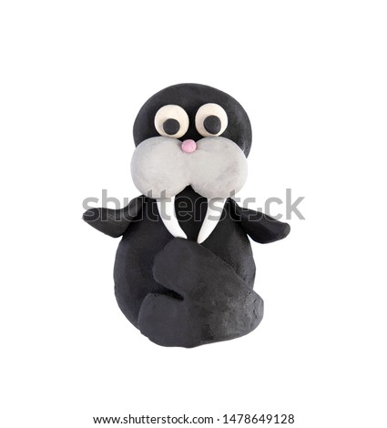 Plasticine walrus isolated on a white background. Walrus blinded by a child from plasticine, mammals.