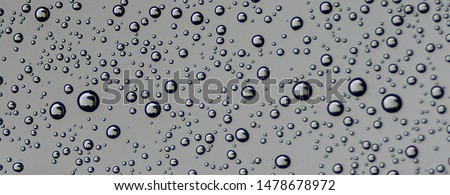 Bokeh and blurred water droplets on auto glass. Soft focus. Air bubble