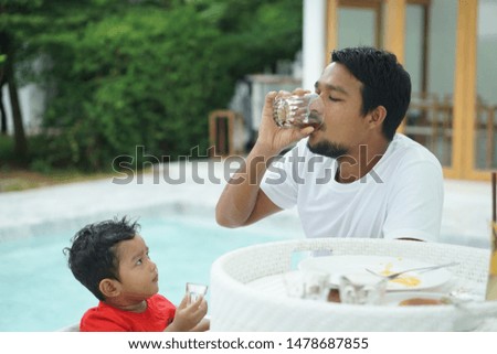 Father and son spend time together on holidays, take care of their love and care for the concept of love and development of their son blur photo not focus.