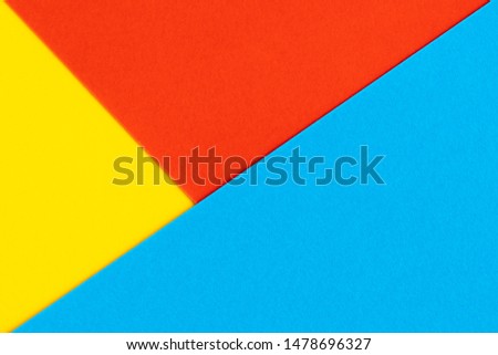 Yelllow blue red color paper background. Geometric figures, shapes. Abstract geometric flat composition. Empty space on monochrome cardboard.