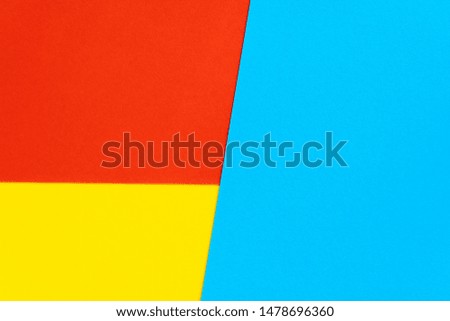 Yelllow blue red color paper background. Geometric figures, shapes. Abstract geometric flat composition. Empty space on monochrome cardboard