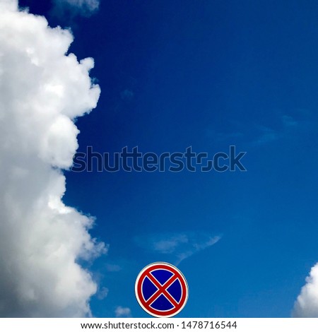 road signs on a background of blue sky with white clouds stop is prohibited