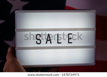 Lightbox with lettering word Sale on Flag of USA. Online shopping concept. 