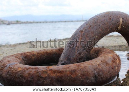 
boat pier and iron rings at sea