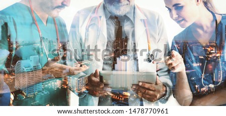 Double exposure group of happy doctor surgeon and nurse with tablet in meeting on city night background, Healthcare and medical concept Royalty-Free Stock Photo #1478770961