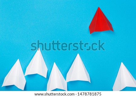 Red paper plane are different from others on blue background. Think different. Business for innovative, solution concepts