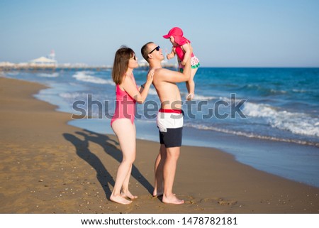 summer vacation and travel concept - portrait of happy family at the beach