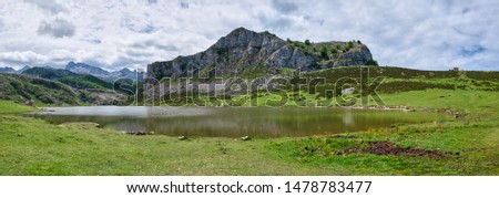 A big panoramic of Lagos de Covadonga (Covadonga mountain lakes), in Asturias. Nature of Spain. Sunny day with blue sky and some clouds. No people. 