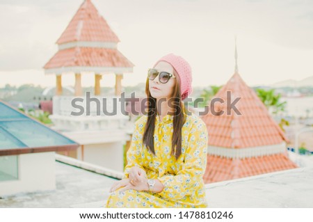 Portrait of happy smiling woman standing on the square on sunny summer or spring day outside  cute smiling woman looking at you  attractive young girl enjoying summer  filtered image  flare sunshine