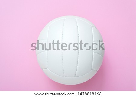 White volleyball leather ball on pink background. Top view.