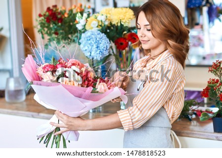 gorgeous good looking smiling seller holding a beautiful bouquet of flowers. close up portrait. love concept