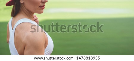 Female model with muscular fit and slim body at the city stadium. Healthy lifestyle