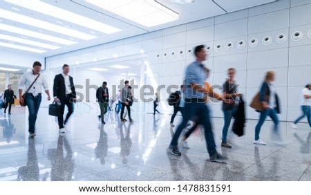 blurred business people in a modern corridor