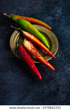 Red hot chille pepper on rustic background with copy space