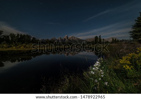 Moonlight illuminates the mountains in Grand Teton National Park