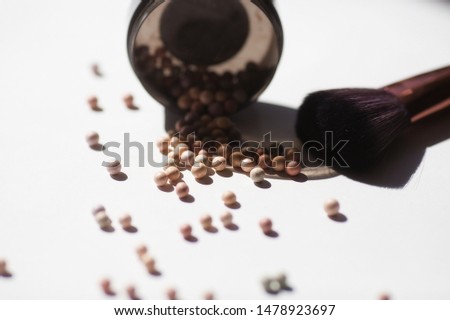 Makeup brushes and powder on a light background. Horizontal template for make-up artist business card or flyer design.