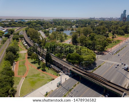 Aerial view with a drone of Palermo forest, railway tracks and Rio de la Plata. Buenos Aires, Argentina.