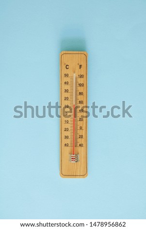 A studio photo of a wall thermometer