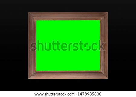 wooden frame with green screen and black wall