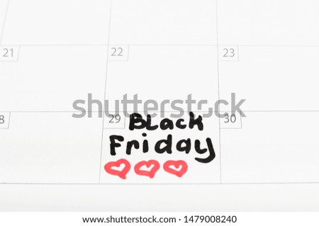 Inscription Black Friday on calendar 2019 and heart sign, close-up