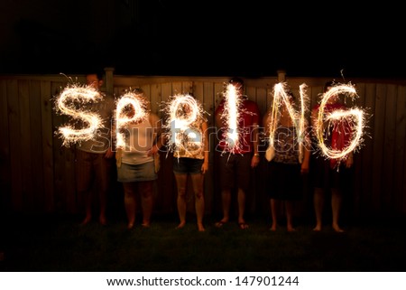 The word Spring in sparklers time lapse photography