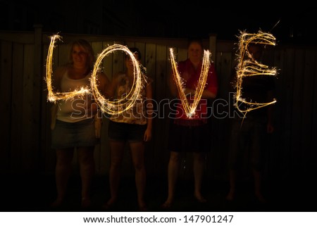 The word Love in sparklers time lapse photography