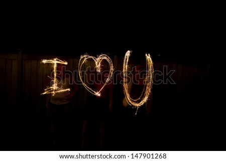 The words I love you in sparklers time lapse photography
