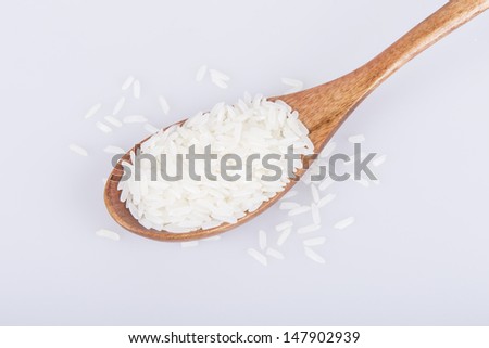 Jasmine rice in a wooden spoon.