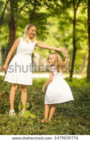 Dance with nature. Mother daughter outdoor.