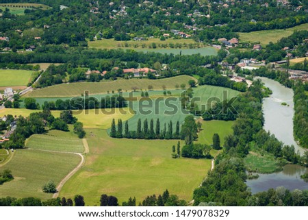 Breathtaking upper view to a little village on a border with France with river and agricultural fields. Alps, Jura mountains, Mont Blanc
