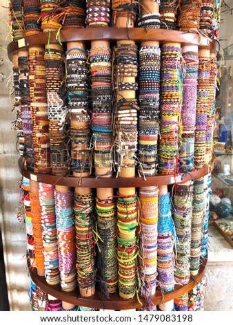 Multiple different bracelets and friendship bands for sale outside a shop