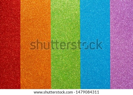 Red, orange, green, blue, purple glitter. Abstract shiny colorful background. A set of texture paper for decoration and design of Christmas, New Year or other holiday pictures. Beautiful packaging