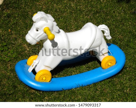 toy horse on the lawn in the garden  