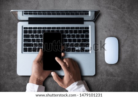 Top view of woman hand using smart phone,mobile payments online shopping,omni docking keyboard computer screen.