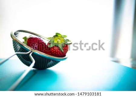 Photo of red strawberries in a strainer