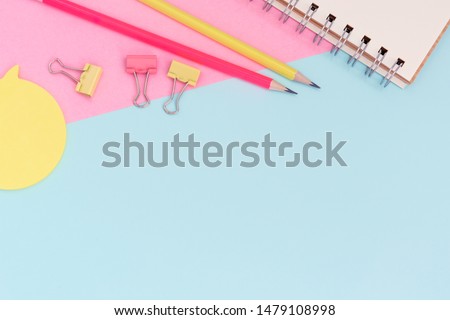 School stationery on a pink and blue background. Back to school creative background, template. Creative, fashionable, minimalistic, office workspace with supplies on pink-blue background. Flat lay.