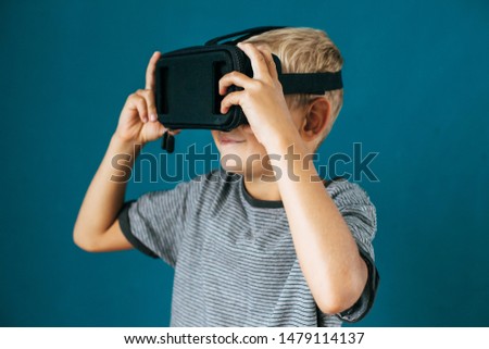 Young boy uses VR-headset display